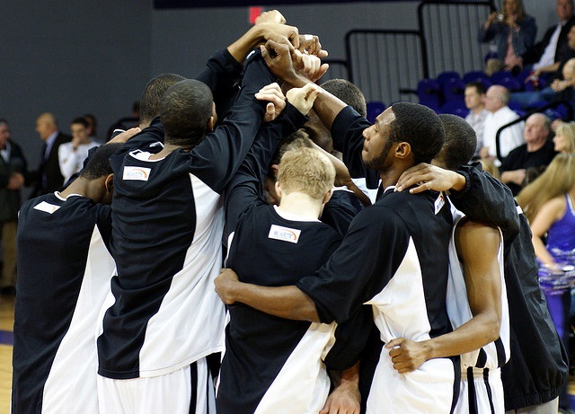 The Men's Basketball team of High Point University unites around their lone senior before the beginning of the final home game of the season. 